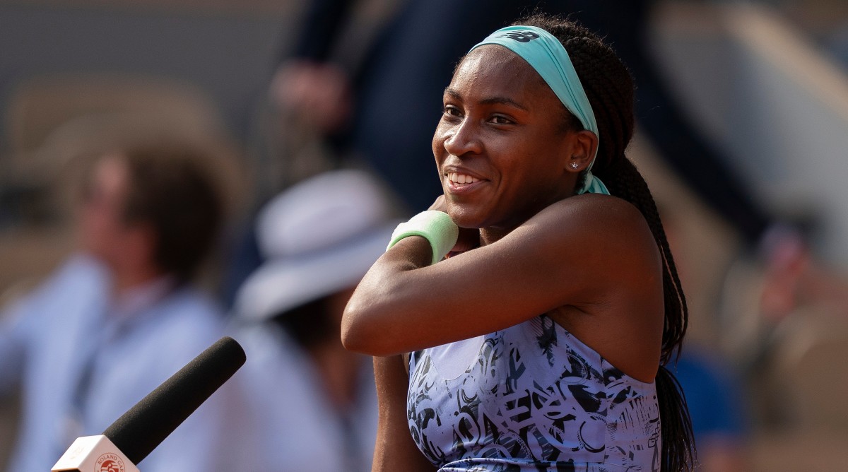 Coco Gauff speaking at a microphone at the French Open